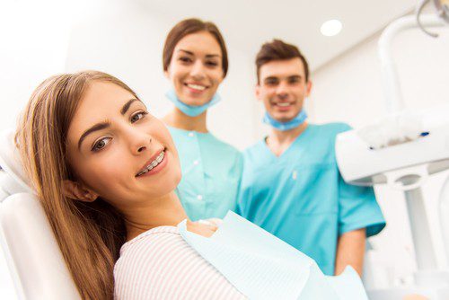 a woman sitting on a dental chair at Dream Smile