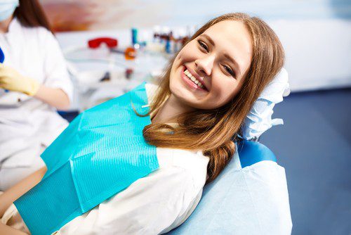 A girl sitting at a dental chair at Dream Smile