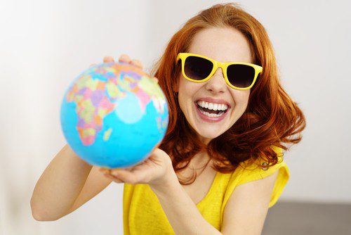 a girl holding a globe